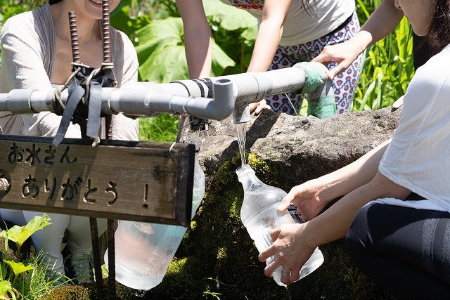 collecting fresh spring water in Niseko